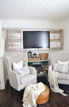 a living room with two chairs and a flat screen tv