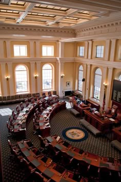 an aerial view of a large room with many chairs and desks in it,