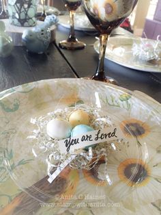 an easter egg nest on a plate with the words you are loved