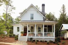 a white house with a porch and covered front porch