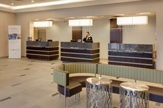 a hotel lobby with two desks and chairs