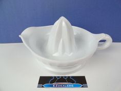 a white ceramic bowl with a cloth in the middle and a blue background behind it