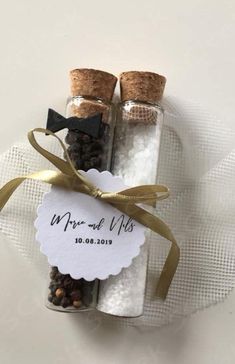 two salt and pepper shakers are wrapped in twine with a tag that says mr and mrs