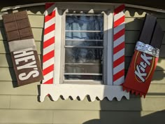 a house decorated for halloween with candy bars hanging from the windows