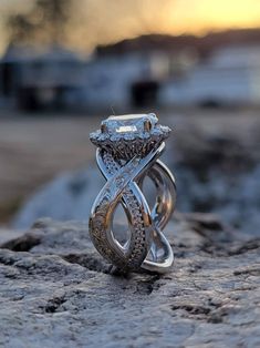 a diamond ring sitting on top of a rock