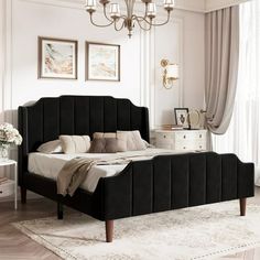 a bedroom with a bed, dresser and chandelier