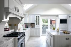 a kitchen with white cabinets and an oven