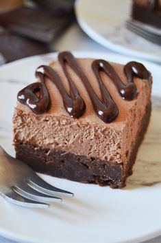 a piece of chocolate cake on a plate with a fork