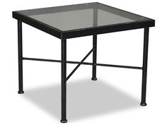 a glass table with metal legs and a black frame on the top, against a white background