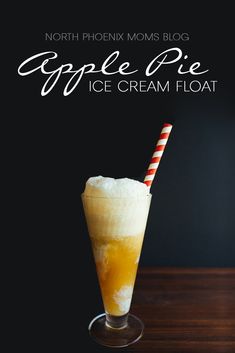 an apple pie ice cream float in a glass with a striped straw on the rim