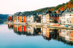 a row of houses sitting on the side of a river