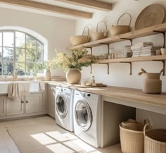 a washer and dryer in a room with open shelves