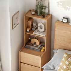 a bed room with a neatly made bed and a wooden book shelf next to it