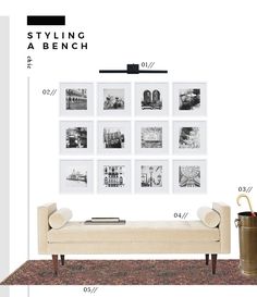 a white couch sitting next to a wall with pictures on it