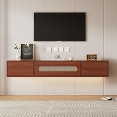 a flat screen tv mounted to the side of a wooden cabinet in a living room