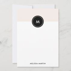 a white and black business card with the letter m on it