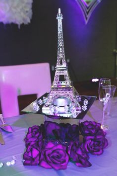 the eiffel tower is made out of glass and has purple roses on it