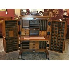 an old fashioned wooden desk with many drawers