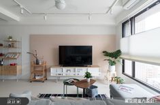 a living room filled with furniture and a flat screen tv on top of a wall