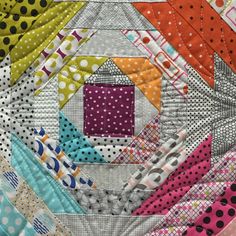 a close up of a colorful quilt with polka dots and an image of a house