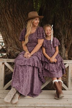 Looking for a modest girl's dress for your next big event? Allow us to introduce you to our Mini Solana Dress! Made from a vibrant purple lace burnout fabric, this dress features a square neckline and short flutter sleeves. The midi-length ruffle tiered skirt adds a touch of playfulness and includes functional pockets, while the hidden back zipper and front corset create a perfect, stylish fit. Country Chic Dresses, Modest Girls Dresses, Modest Girl, Burnout Fabric, Vibrant Purple, Purple Lace, Dress Purple, Tier Skirt, City Girl