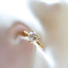 a diamond ring sitting on top of a white cloth