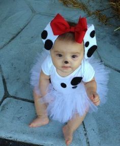 a baby girl wearing a white and black polka dot tutu