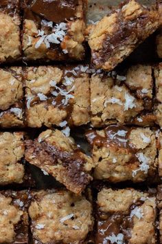 some brownies are cut into squares with coconut on top