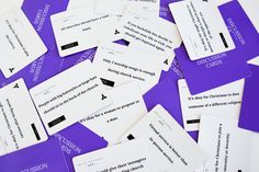 purple and white business cards are scattered on top of each other