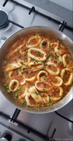 a pan filled with pasta and sauce on top of a stove