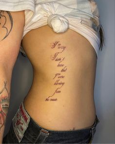 a woman's lower back with tattoos on her stomach and the words, i love you