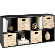 a black shelf with baskets and books on it, next to a white bookcase