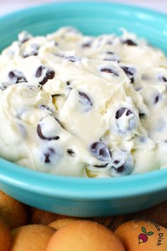 a blue bowl filled with cream and chocolate chips