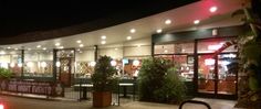 a car parked in front of a restaurant at night