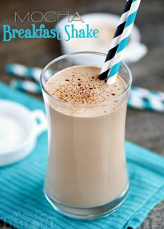 mocha breakfast shake in a glass with a blue and white striped straw