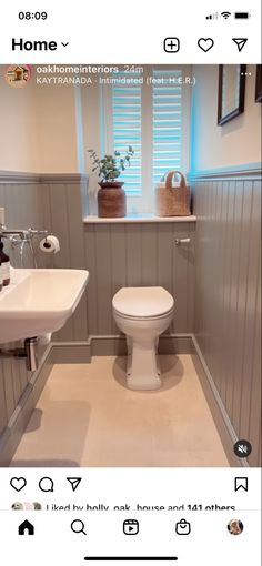 a white toilet sitting next to a sink in a bathroom under a window with shutters