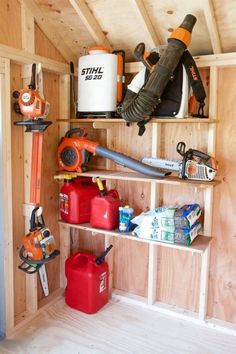 the inside of a storage shed with tools and supplies on shelves, including an air blower