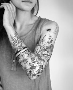 a woman with tattoos on her arms and arm