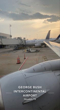 an airplane is parked on the tarmac with other planes in the background and text that reads, george bush intercontenial airport houston tx