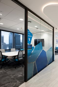 an office with glass walls and blue accents