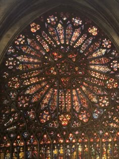 a large stained glass window inside of a cathedral