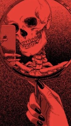 a hand holding a magnifying glass looking at a skull in it's reflection