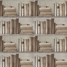 several rows of books lined up against a wall with linen coverings on the shelves