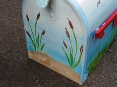 a painted mailbox sitting on the ground