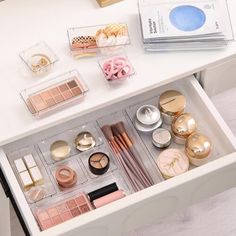 the drawers are filled with makeup and other items on top of each other's desk