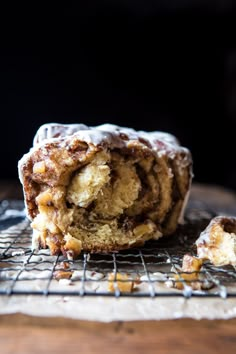 a close up of a pastry on a cooling rack with one bite taken out of it