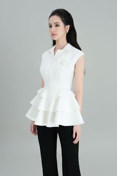 The shirt proves its charm when transforming impressively on a classic white tone. Designed with a novelty wavy peplum style that accentuates the overall costume and makes it more eye-catching and feminity. Note:*Processing time takes 13-17 working days (including 10-15 working days for manufacturing and NOT including shipping time)**Made To Order Definition:- The product is currently unavailable and not in mass production.- The product will be manufactured immediately after its order has been p Chic Peplum Tops For Formal Occasions, Chic Formal Peplum Tops, White Peplum Blouse With Ruffles, White Ruffled Peplum Blouse, Formal Summer Peplum Top, White Ruffled Evening Top, Classic White Tops For Party, Elegant White Sleeveless Top, Elegant White Ruffled Tops