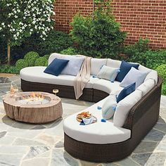 a couch and table sitting on top of a stone patio