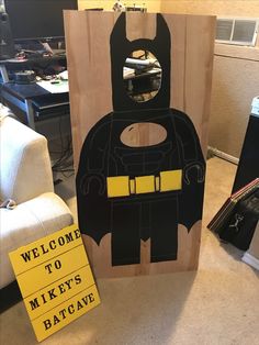 a wooden sign with a batman cut out on it