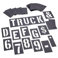 truck decals and stickers are laid out on a white surface, including one dollar